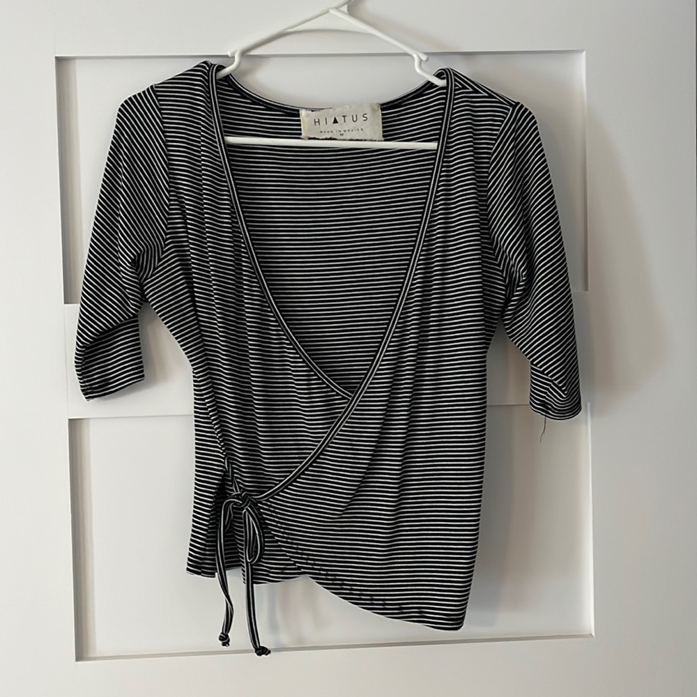 Knit black and white striped wrap style top, size medium